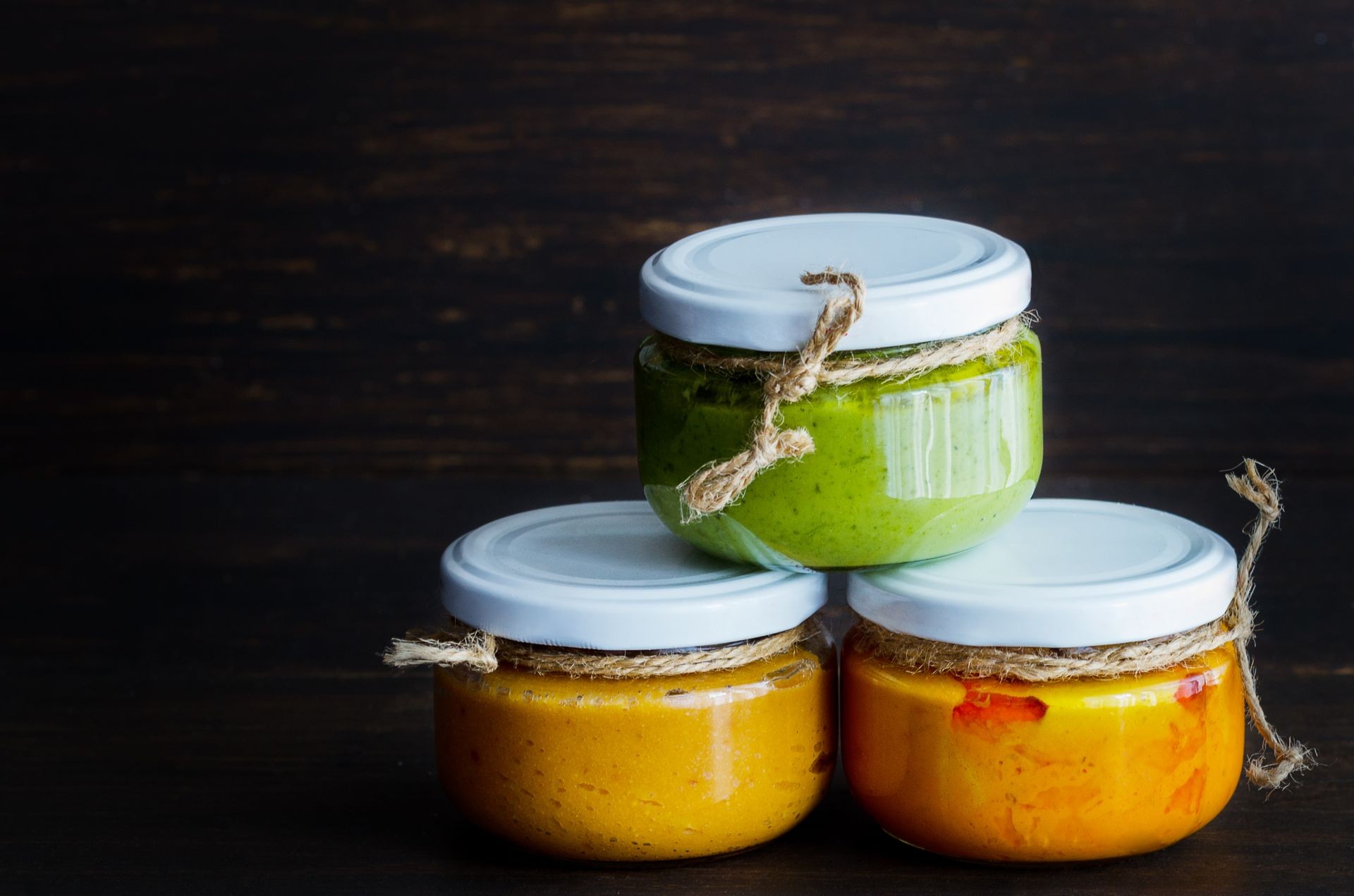 Several types of typical Canary Islands sauces in glass jar: Mojo picon, mojo verde  made and almogrote are popular souvenirs of the fun holiday experience. Copy space