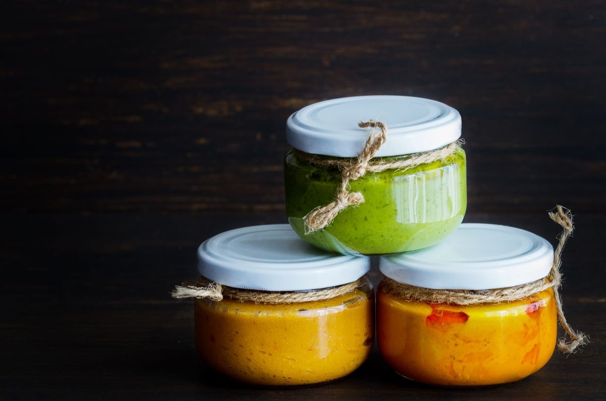 Several types of typical Canary Islands sauces in glass jar: Mojo picon, mojo verde  made and almogrote are popular souvenirs of the fun holiday experience. Copy space